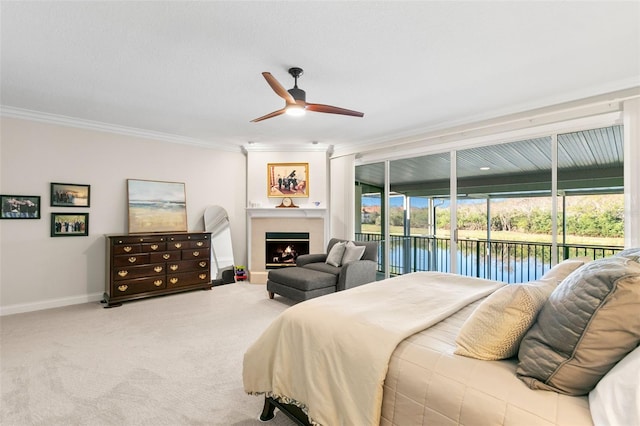 bedroom with crown molding, ceiling fan, carpet flooring, a water view, and access to outside