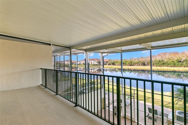 balcony featuring a water view and central air condition unit