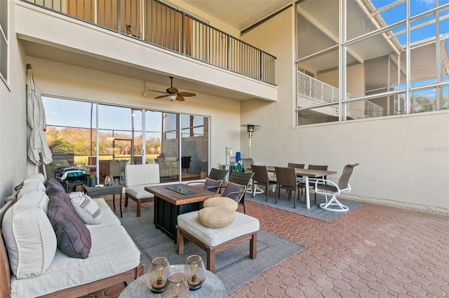 view of patio featuring an outdoor living space with a fire pit and ceiling fan