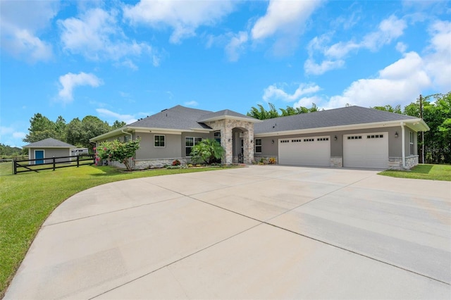 ranch-style house with a garage and a front yard