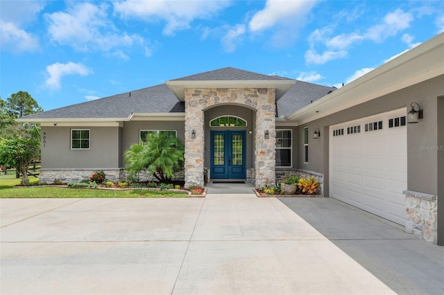 view of front facade with a garage and french doors