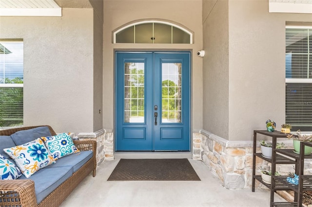 doorway to property featuring outdoor lounge area and french doors