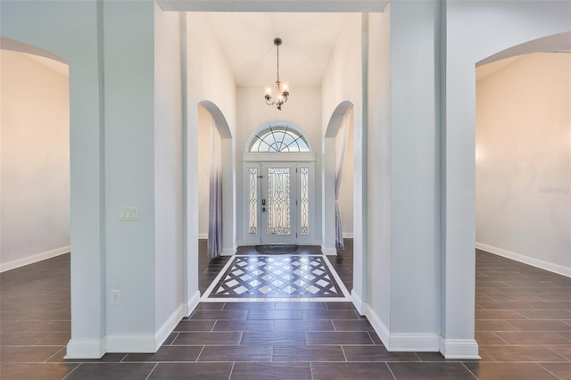 foyer with a high ceiling and a chandelier