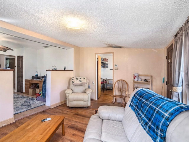 living room featuring hardwood / wood-style flooring and a textured ceiling