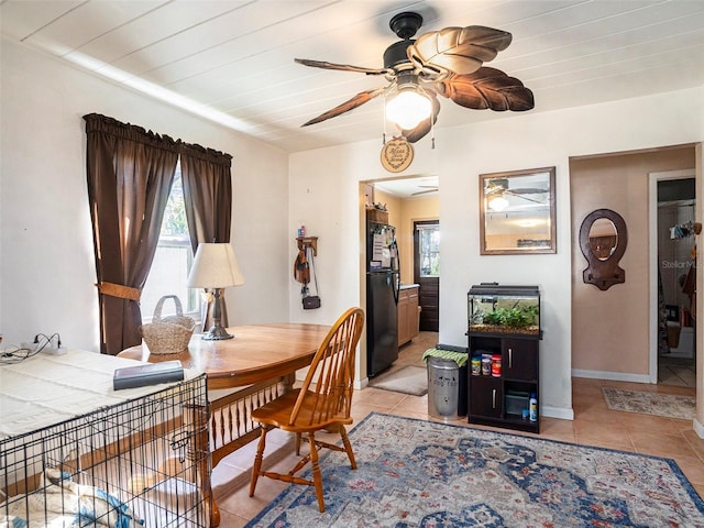 tiled dining room featuring ceiling fan