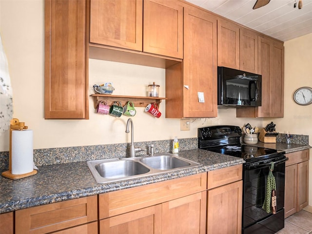 kitchen featuring sink, light tile patterned floors, ceiling fan, dark stone countertops, and black appliances