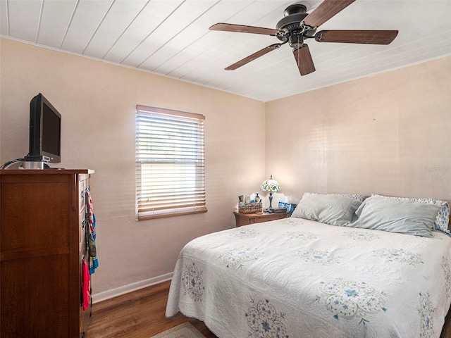 bedroom with dark wood-type flooring, wooden ceiling, and ceiling fan