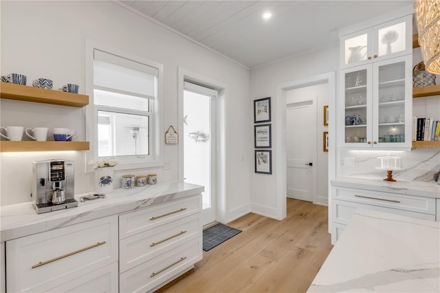 bathroom featuring hardwood / wood-style flooring, crown molding, and decorative backsplash