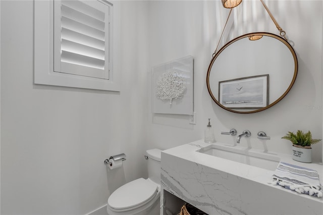 bathroom featuring sink and toilet