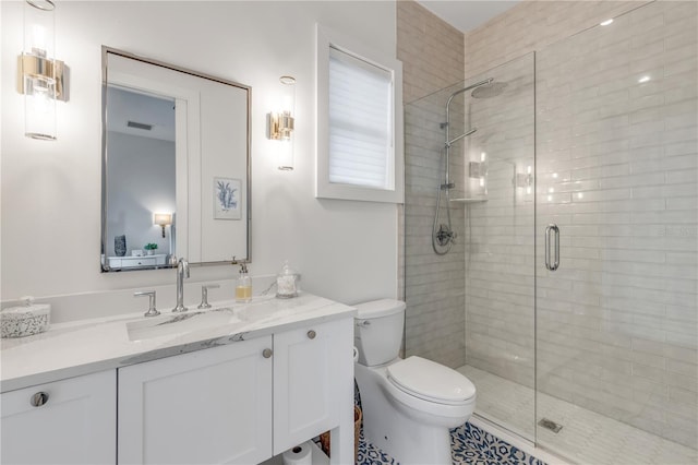 bathroom featuring vanity, a shower with door, and toilet