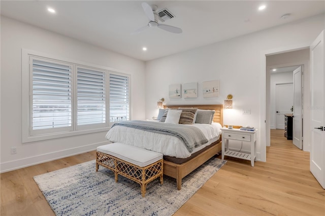 bedroom with light hardwood / wood-style floors and ceiling fan