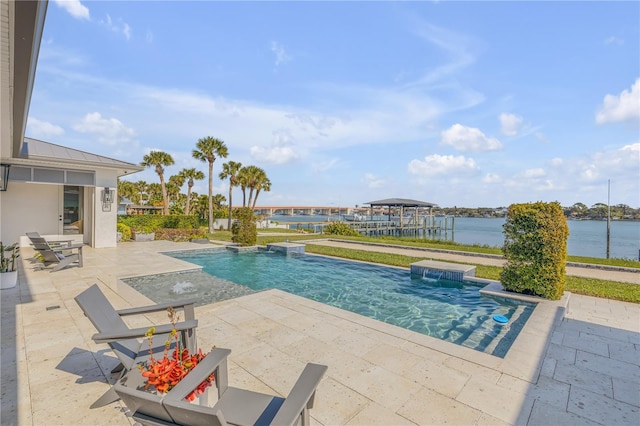 view of swimming pool featuring a hot tub, a water view, pool water feature, and a patio area