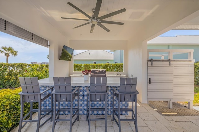 view of patio / terrace with ceiling fan and an outdoor bar