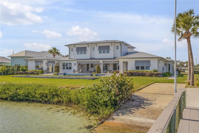 exterior space with a yard and a water view