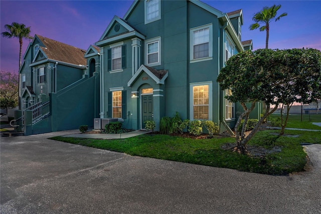 view of front of house featuring central air condition unit and stucco siding