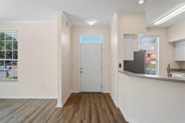 entrance foyer with recessed lighting, baseboards, dark wood-style flooring, and ornamental molding