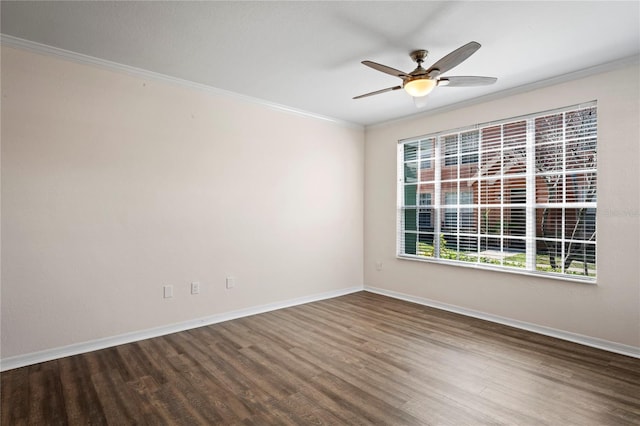 empty room featuring a ceiling fan, crown molding, wood finished floors, and baseboards