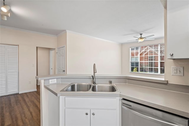 kitchen featuring white cabinetry, a sink, dark wood-type flooring, dishwasher, and crown molding