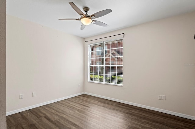 empty room with ceiling fan, baseboards, and wood finished floors