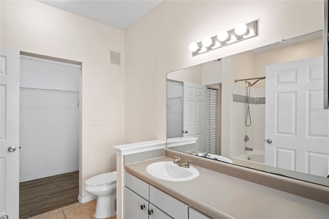 bathroom with vanity, visible vents, tile patterned flooring, bathing tub / shower combination, and toilet