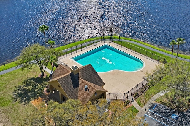 view of pool with fence, a fenced in pool, and a water view