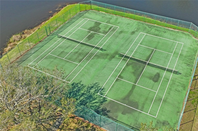 view of tennis court with a rural view and fence