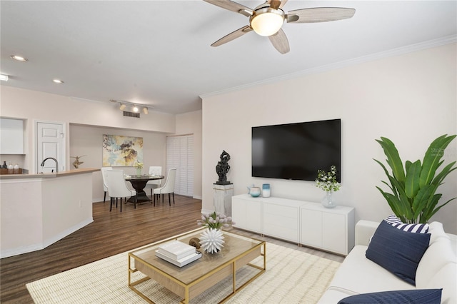 living room with a ceiling fan, recessed lighting, wood finished floors, and ornamental molding