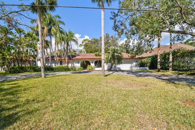 view of front of house with a garage and a front lawn