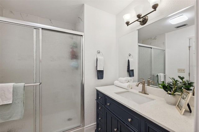 bathroom with vanity and a shower with door