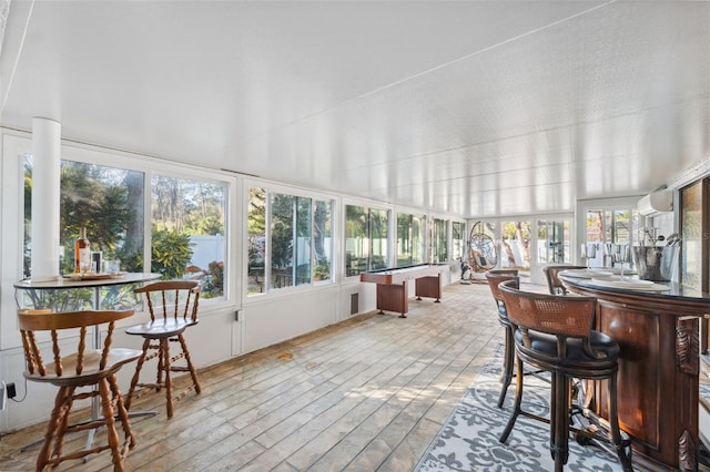 sunroom featuring a wall unit AC