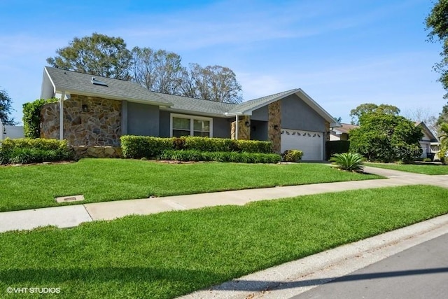 single story home with a garage and a front lawn