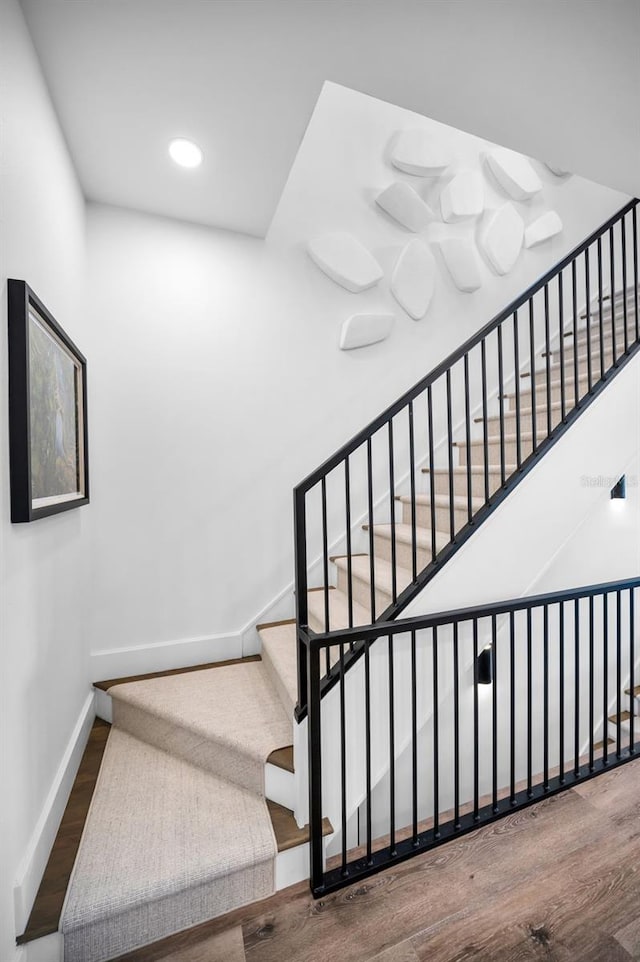 stairs with wood-type flooring