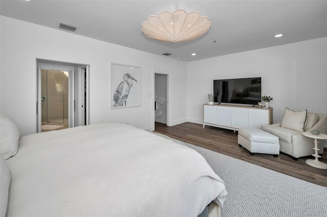 bedroom featuring dark hardwood / wood-style flooring and ensuite bath