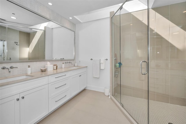 bathroom featuring tasteful backsplash, vanity, and walk in shower