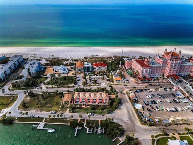 birds eye view of property with a water view and a beach view