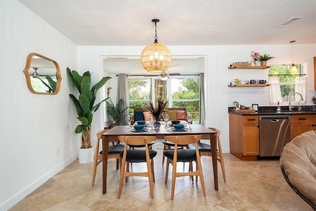 dining room with sink and a notable chandelier