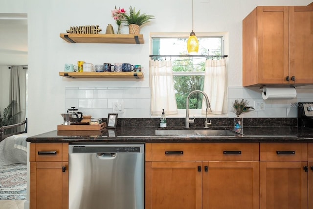 kitchen featuring sink, dishwasher, dark stone countertops, hanging light fixtures, and tasteful backsplash