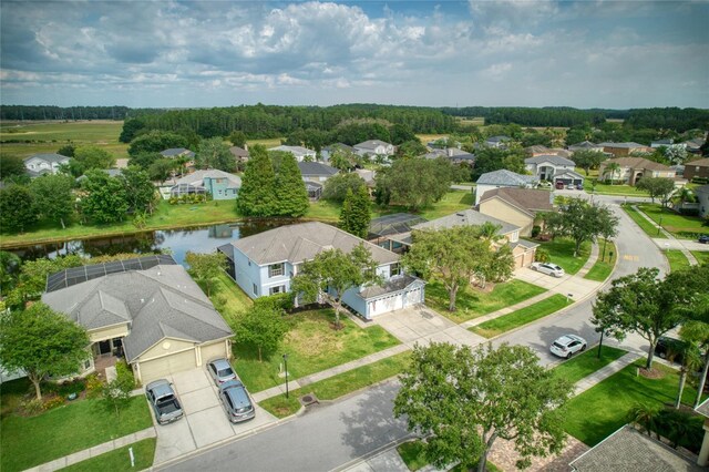 birds eye view of property with a water view and a residential view