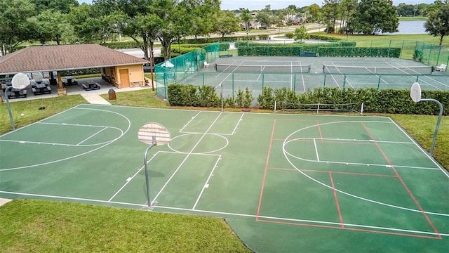 view of sport court featuring a yard, community basketball court, and fence