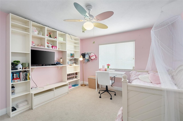 home office featuring carpet flooring, ceiling fan, and baseboards