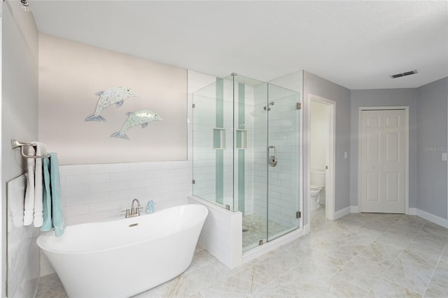 full bath with toilet, a freestanding tub, visible vents, and a shower stall