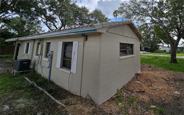 view of side of property featuring central AC