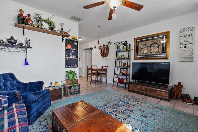 living room with ceiling fan and light tile patterned floors