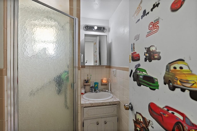 bathroom with vanity, decorative backsplash, and a shower with shower door