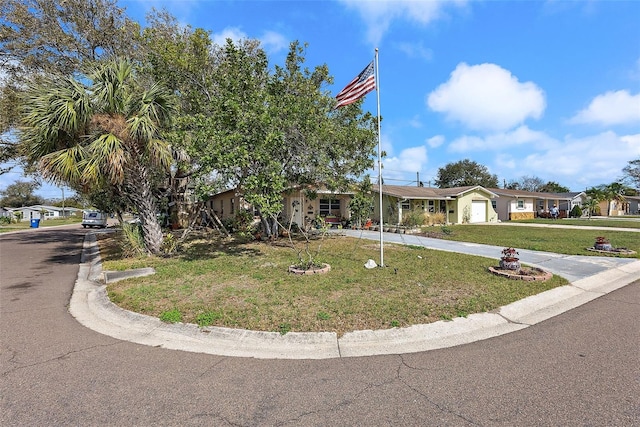 view of front of property with a front lawn, driveway, and a residential view