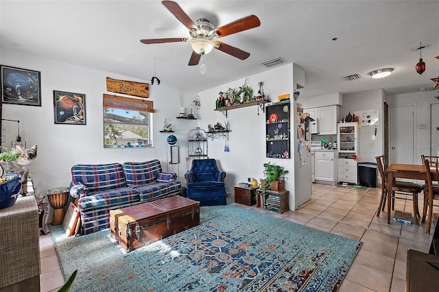 living room with visible vents, a ceiling fan, and light tile patterned floors
