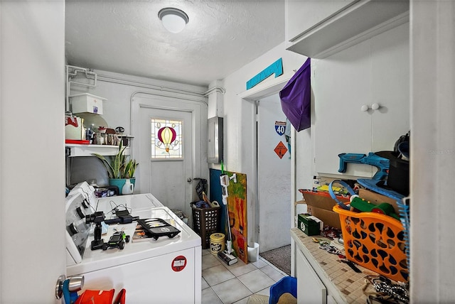 kitchen with tile counters, a textured ceiling, washer / clothes dryer, and light tile patterned floors