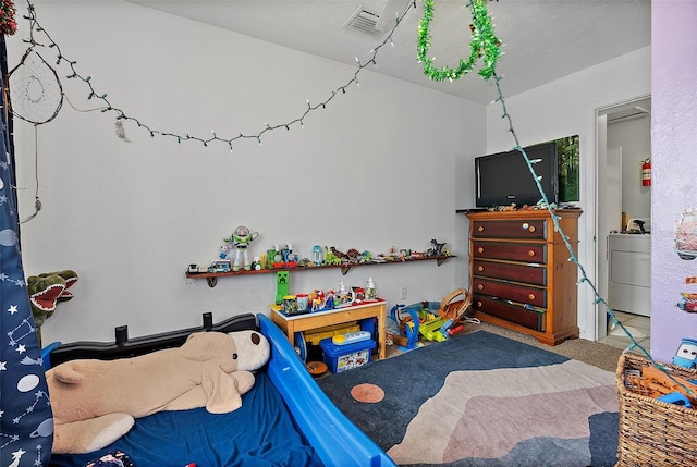 recreation room featuring carpet floors and washer / dryer