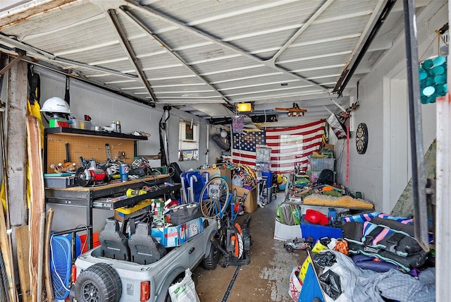 garage featuring concrete block wall and a garage door opener