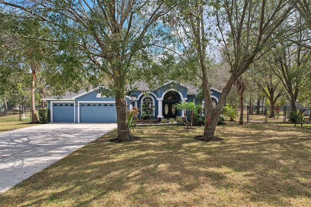 view of front of property featuring a garage and a front yard